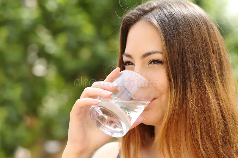happy woman drinking water glass outdoor healthy fresh green background 42150243